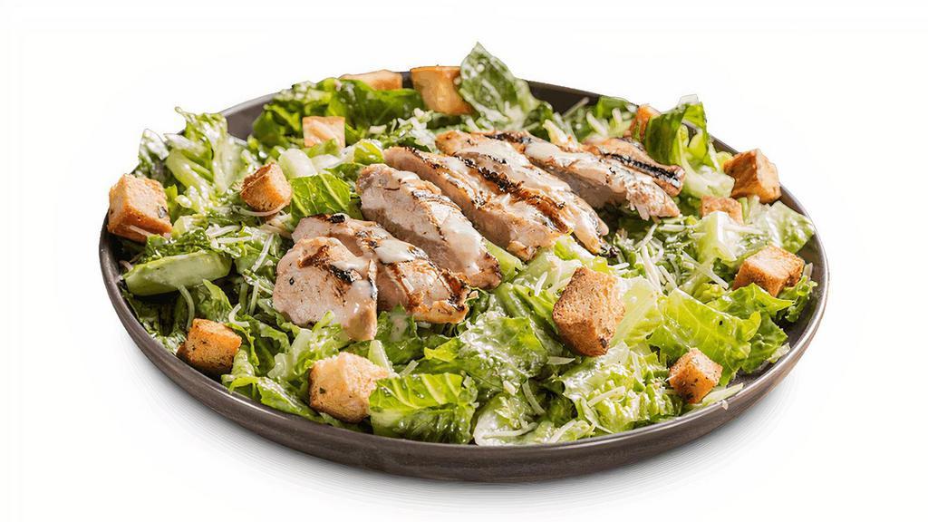 Chicken Caesar Salad · Crisp romaine lettuce topped with sliced, grilled chicken breast and Caesar dressing on the side. Served with a Corn Bread Muffin.