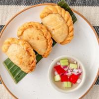 Curry Puffs · Pastry stuffed with chicken, potatoes, onions and curry powder.