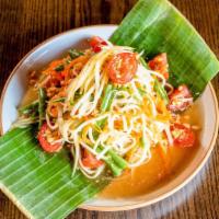 Green Papaya Salad · Julienne raw papaya tossed with tomatoes, carrots, string beans and peanuts in Thai vinaigre...