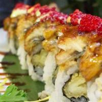 Sex On The Beach Roll · Shrimp tempura roll, topped with eel, tobiko and three kinds of sauces.