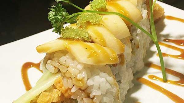 Fuji Roll · Soft shell crab tempura with spicy tuna, topped with white tuna and wasabi tobiko.