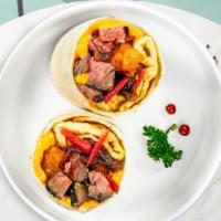 Philly Breakfast Burrito · A warm wrap stuffed with scrambled eggs thin sliced Philly steak, onions, bell peppers and c...