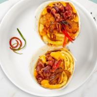 Wholesome Breakfast Burrito · A warm wrap stuffed with turkey bacon, egg whites, crispy home fries, sauteed peppers and on...