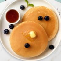 Wild Blueberry Pancakes · Three buttermilk pancakes loaded with wild blueberries.
