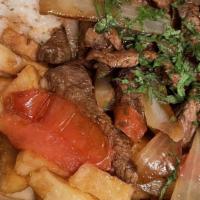 Lomo Saltado · Con arroz/Sauteed beef mixed with onions, tomatoes, & french fries served with white rice