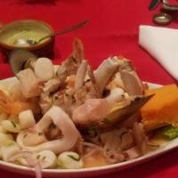Ceviche Mixto · Bits of fish, shrimp, and octopus mixed with boiled sweet potatoes, Peruvian corn (choclo) &...