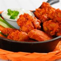 Buffalo Wings · Eight pieces of oven-baked buffalo wings.