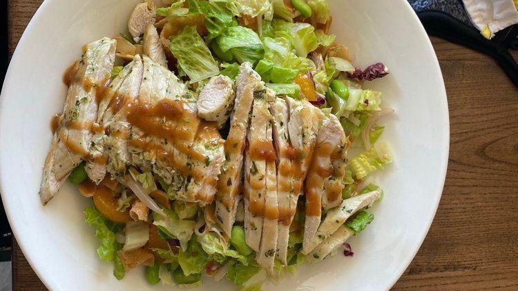 Asian Chicken Salad · Romaine, bean sprouts, mandarin oranges, edamame, crispy wontons, grilled chicken, almonds and ginger dressing.
