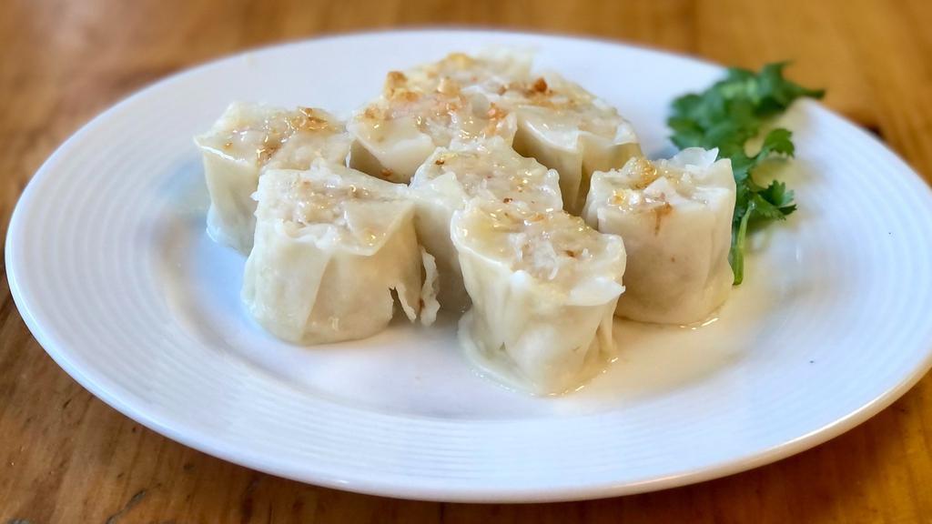 Shrimp Shumai (8 Pieces) · Steamed or fried dumplings stuffed with shrimp and onion wrapped in wheat flour skin. 
- Steamed shumai served with soy vinaigrette sauce and topped with fried garlic oil.
- Fried shumai served with sweet chili sauce.