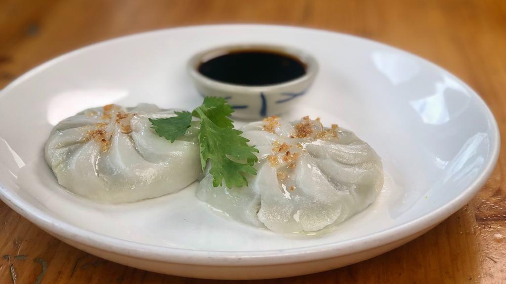 Chive Dumpling (2 Pieces) · Steamed or fried dumpling stuffed with chive wrapped in rice skin. Steamed served with soy vinaigrette sauce and topped with fried garlic oil. Fried served with sweet chili sauce.
