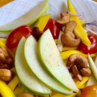 Mango Apple Salad · Shredded mango, green apple, mixed green salad, red onion, tomato, and cashew nuts with lime...
