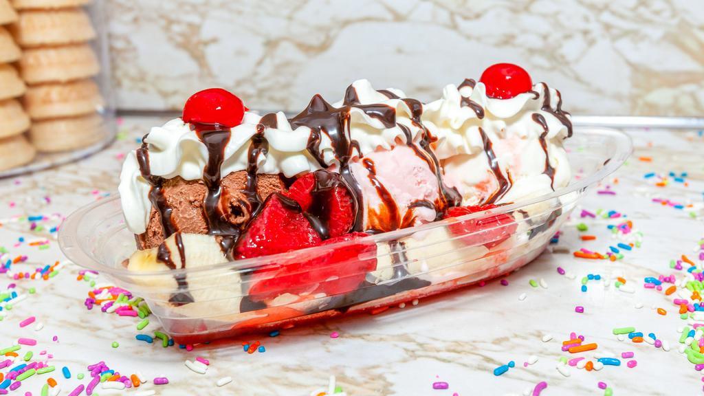Banana Split · choose any three hard ice cream flavors, includes pineapple, strawberries, peanuts, hot fudge, whipped cream and a  cherry