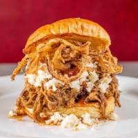 Pulled Pork · Topped with coleslaw and crispy onions on a potato bun.