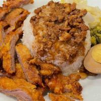 Chinese-Style Fried Pork Chop With Rice / 排骨飯 · Chinese-style fried pork chop served over braised pork sauce, rice, a braised egg, and pickl...