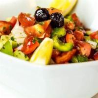 Shepherd Salad · Chopped tomatoes, cucumber, green peppers, parsley, onions, olive oil, and fresh lemon.