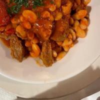 Lamb And Beans · Lamb and white bean stewed in tomato sauce. Served with rice.
