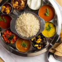 South Indian Thali · Rasam, sambar, kootu, cal, poriyal, special rice, chapathi, white rice, yogurt, pickle, papa...
