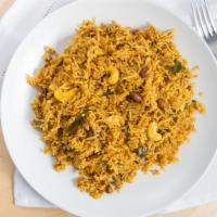 Tamarind Rice · Vegan. Rice mixed with tamarind and peanut sauce garnished with fresh curry and coriander le...