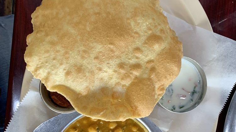 Chole Poori · Vegan. A fluffy deep-fried whole wheat bread served with chickpea curry.