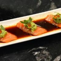 Yuzu Spicy Salmon · Salmon sashimi with spicy yuzu sauce topped with avocado and ikura.