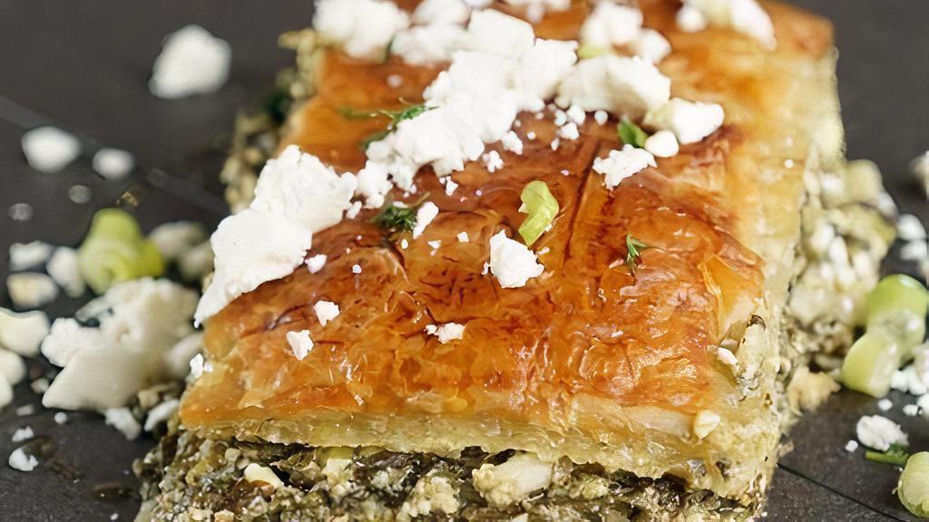 Spanakopita · Spinach Pie chopped spinach, feta cheese, onions & scallions, egg, and seasoning The filling is wrapped in phyllo (filo) pastry with butter & olive oil.