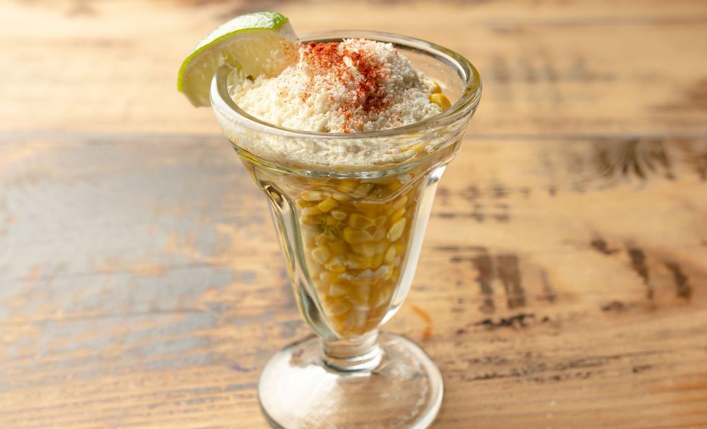 Esquites · Corn kernels, epazote, chile, mayo and lime juice with cotija cheese.
