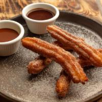 Churros · Two dipping sauces, caramel and Mexican chocolate.