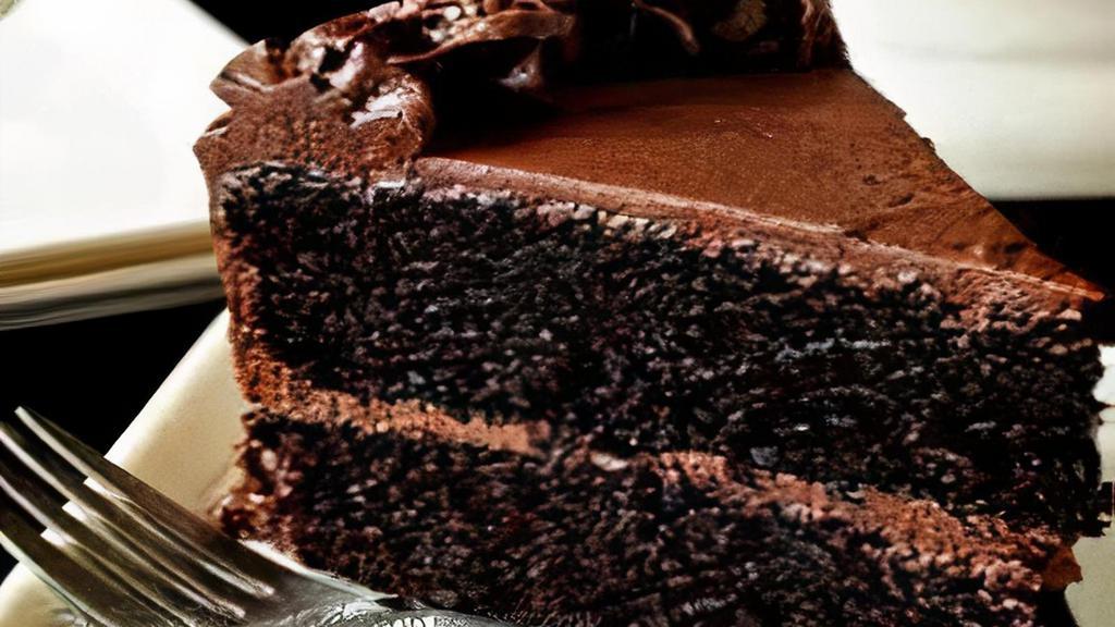 Ultimate Chocolate Cake · A foundation of chocolate decadence, a layer of chocolate mousse, and a layer of chocolate butter cake