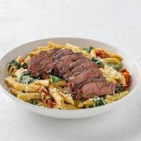 Sirloin Penne  · Grilled sliced sirloin on penne pasta with portabella mushrooms, roasted tomatoes, and fresh...