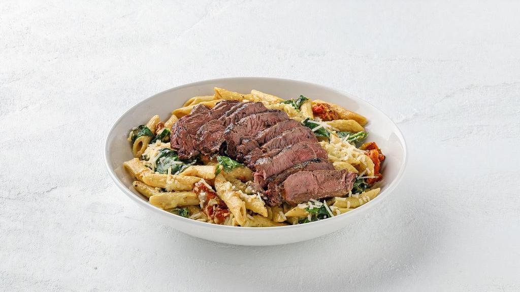 Sirloin Penne  · Grilled sliced sirloin on penne pasta with portabella mushrooms, roasted tomatoes, and fresh spinach in Aji-Amarillo pepper cheese sauce, topped with grated Parmesan.