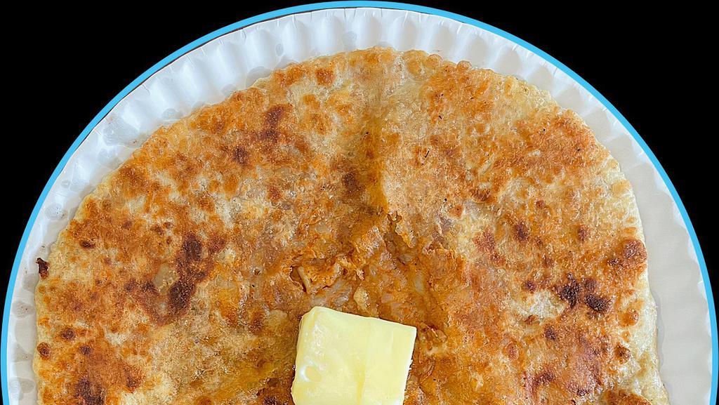 Aloo Paratha · Flatbread stuffed with tender potatoes and served with a side of yogurt. Vegan.