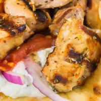 Chicken Souvlaki Pita · served with tomatoes, red onions and tzatziki all wrapped inside a toasted regular pita