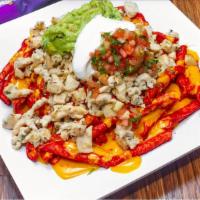 Takis Fuego Nachos · HOT TAKIS Fuego Tortilla Chips cover with Nacho Cheese Sauce and any Taco Meat. Topped with ...