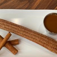 Churro Loco · Fried Mexican dough dusted with cinnamon and sugar stuffed with dulce de leche.