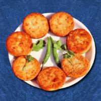 Crafted Potato Patty · Golden fried-potato patty stuffed with peas and served with a spicy relish.