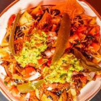 Al Pastor Nachos · Spicy Pork With Pineapples corn tortilla chips, Refried black beans, mixed cheddar cheese, g...