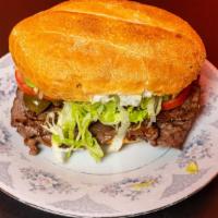 Philly Cheese Steak Torta · Steak, Green Bell Peppers, White Onions, Cheddar Cheese, Swiss Cheese.