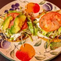 Tinga Tostadas · Spicy Shredded Chicken. Hard Corn Tortilla Topped with Lettuce, Sour Cream, Refried Black Be...
