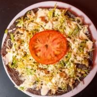 Pollo Huaraches · Shredded Chicken, Handmade Corn Huarache Smashed Black Beans inside the corn, Topped with le...