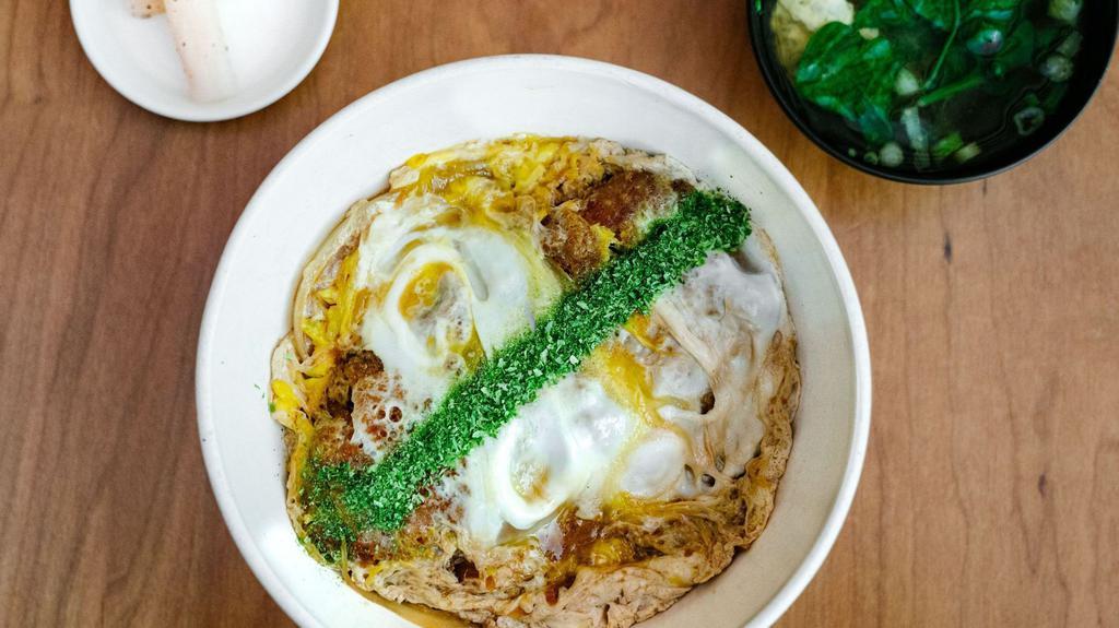 Katsu Don · Deep fried Japanese corn-fed pork cutlet, onion, egg rice bowl. Served with soup, pickle.