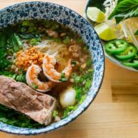 Hu Tieu Em · Our signature soup noodle dish features a savory pork broth, shrimp, pork ribs, chives and r...