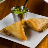 Sambusa (Dinner) · Two triangular pastries stuffed with lentil and pepper mix and served with a spicy cilantro ...
