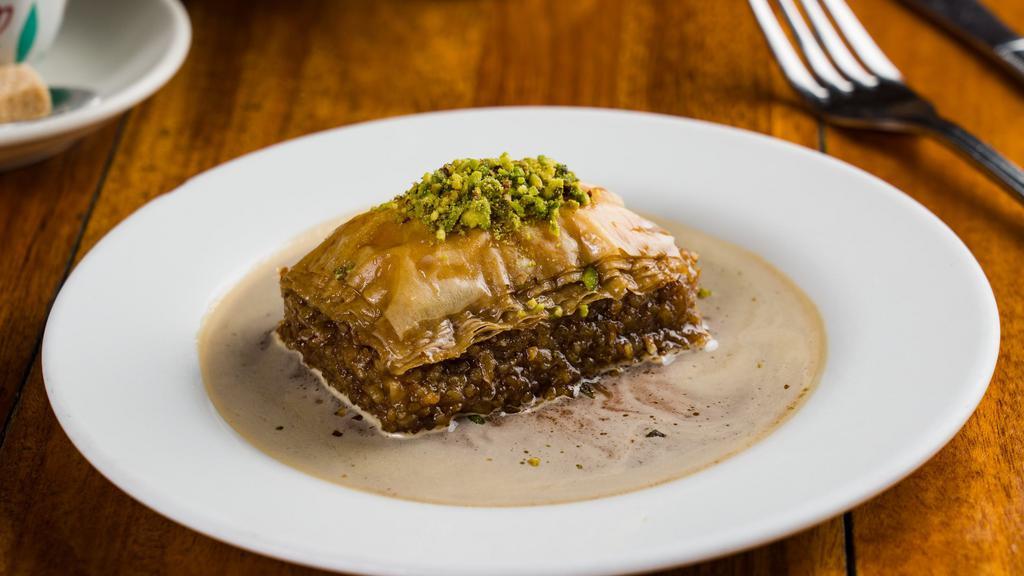 Baklava · Vegan. Light, crispy filo dough with pistachio, roasted walnuts, and served with coffee-infused demerara syrup.