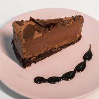 Chocolate Mousse Cake · Chocolate mousse with a layer of chocolate cake topped with chocolate shavings.