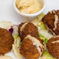 Falafel · Five piece. Chickpeas, parsley, onions, and garlic mashed and lightly fried. Served with hum...