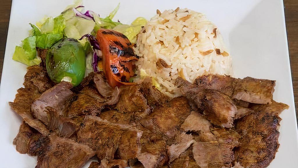 Doner Gyro · Ground lamb wrapped around a large vertical spit and grilled in front of an ingenious tier of charcoal fires. Served with rice and salad.