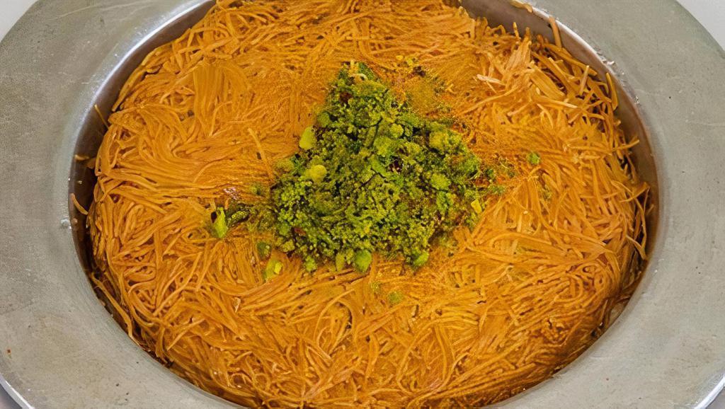 Kunefe · Two layers of crunchy golden kadayif, filled with cheese and baked until golden and crispy and steeped in syrup.
