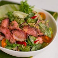 Grilled Beef Salad · Summer crisp, lemongrass, mint, cilantro, lime, and Nam pla dressing.
