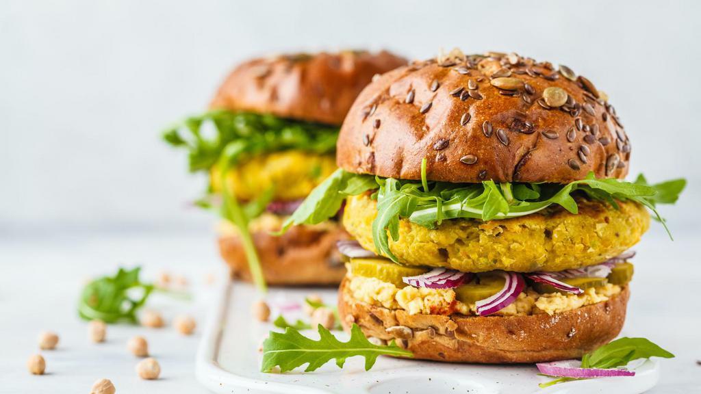 The Vegan Burger · Fresh vegan patty, lettuce, tomatoes, and ketchup on a fresh-baked bun.