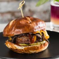 Smokey Bbq Burger · Beyond burger patty, BBQ Portobello, caramelized onion, American cheese, and pickle on a pre...